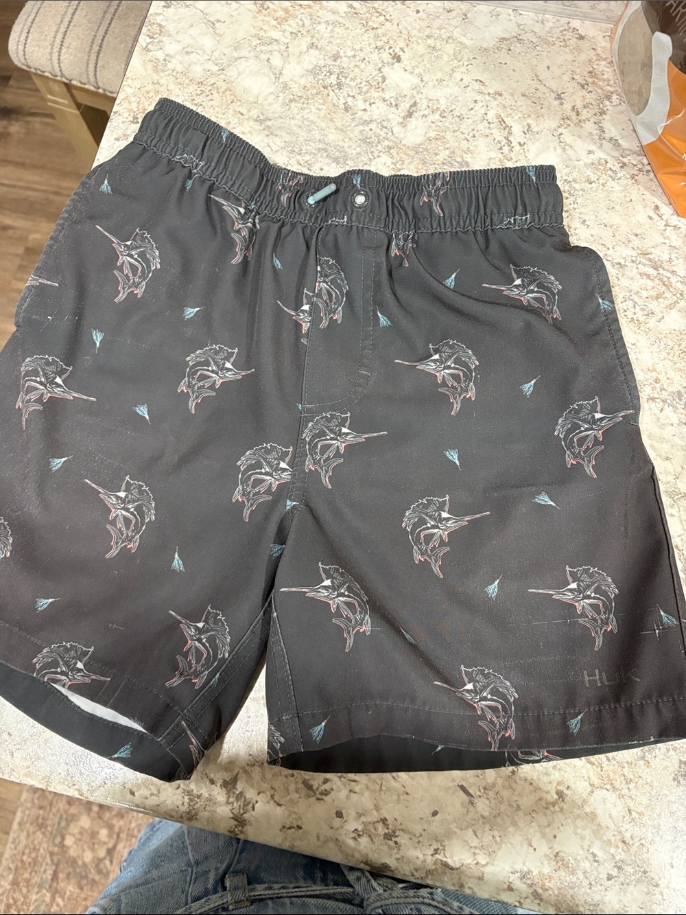 Huk Black Marlin-Print Kids Swim Shorts with Teal Accents